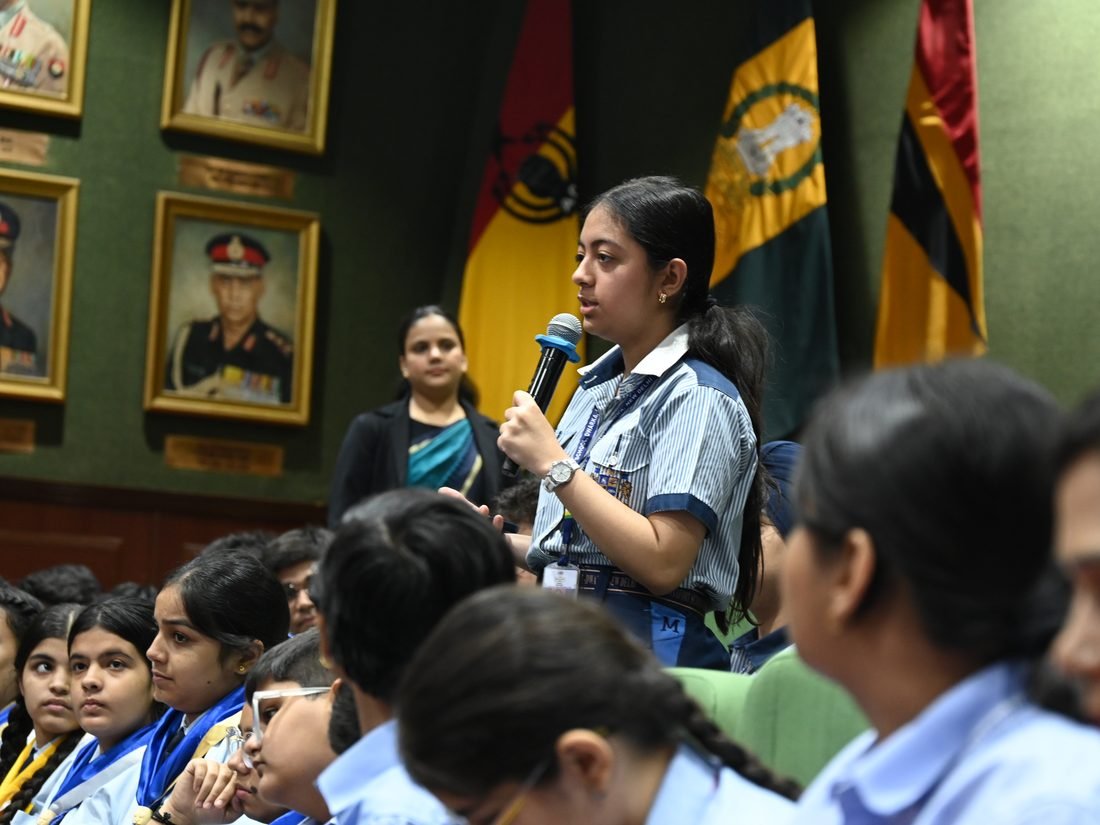A student stands to ask a question